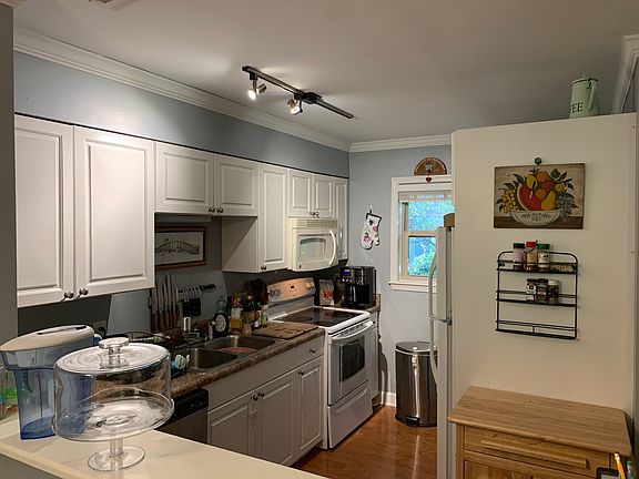 Kitchen, recently replaced dishwasher, brand-new washer/dryer in apt next to fridge.