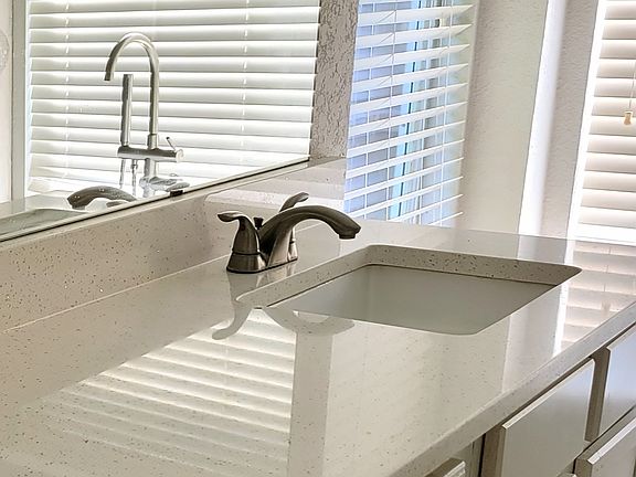 Bathrooms Quartz counters & wave bowl sinks!