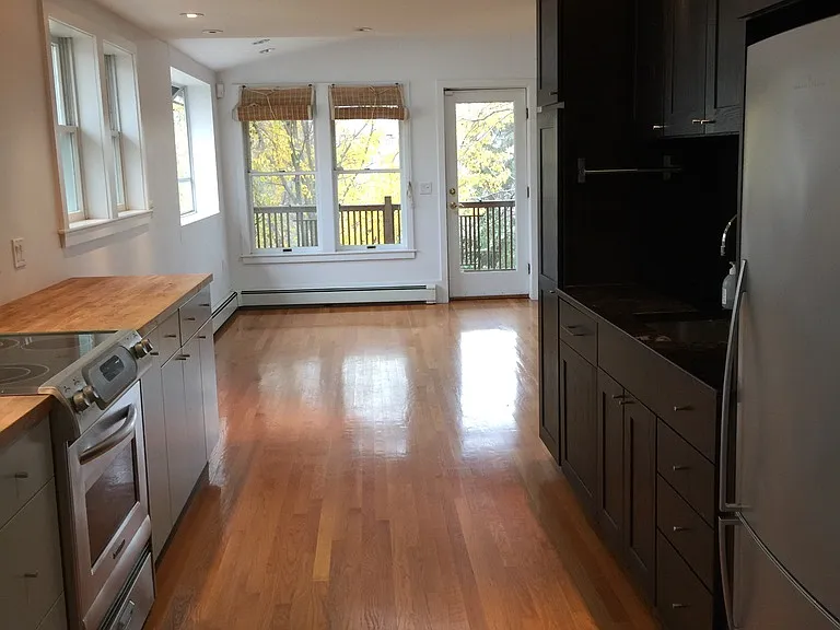 Kitchen looking into living room, overlooking balcony.