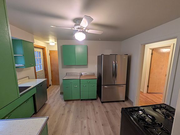 Kitchen has two pantry closets and door to access side/back porch.