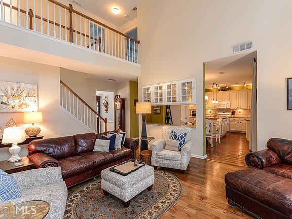 UNIQUE OPEN WALL TO KITCHEN DEFINES EACH SPACE BUT GIVES AN OPEN FEELING AND PROVIDES EXTRA STORAGE 