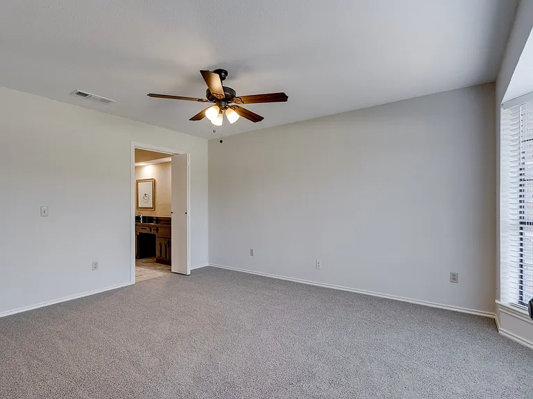 Large Master bedroom with a bay window.