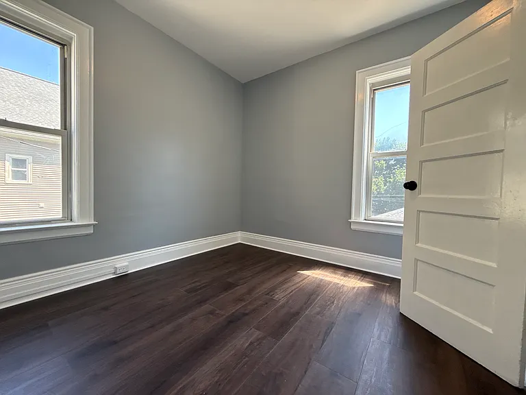 Bedroom 1 with 2 windows and 1 closet