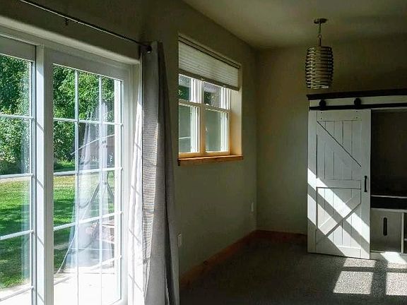 Views to the back patio and yard. Spacious and open feel with lots of natural light and warmth.