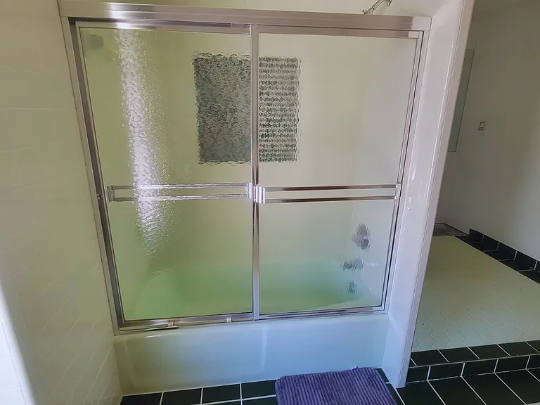 Spacious, spotless shower with modern tile finishes.
