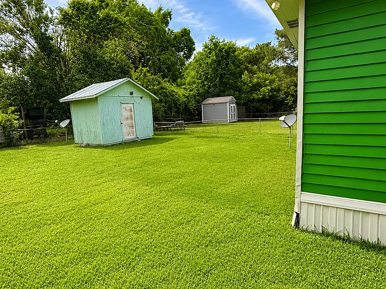 Fenced Backyard with storage building and plenty of room to relax and play.