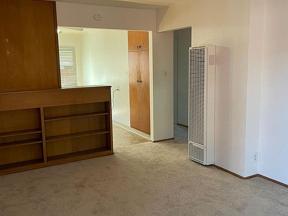 Living room has furnace & storage space