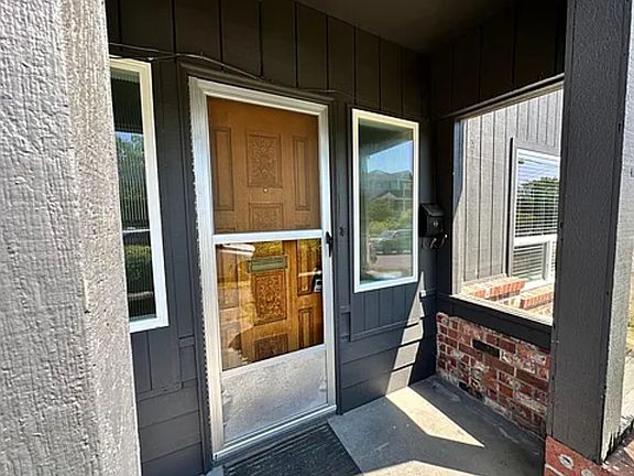 Front door and covered porch with screen door to let fresh air in.