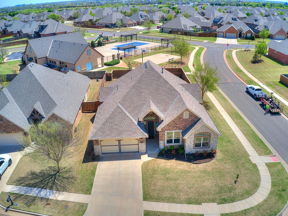Aeriel view of house and community pool and clubhouse behind