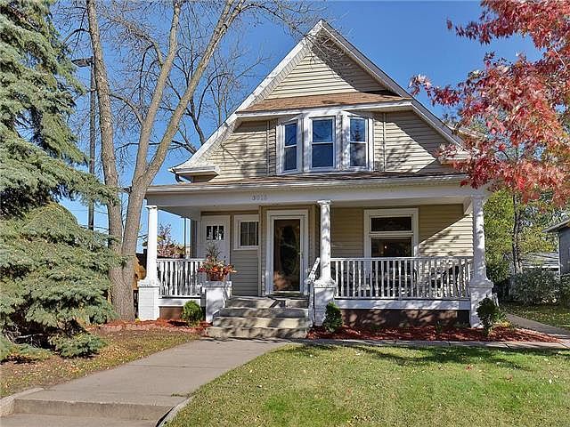 Uptown bungalow with covered front and back entrances.