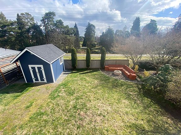 Big backyard with bench, firepit area, and shed. Backyard backs up to the Interurban trail