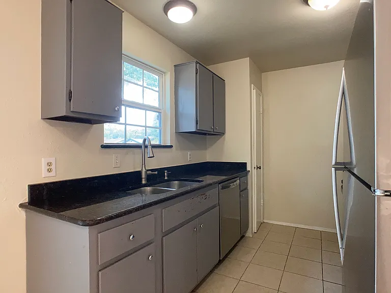 Kitchen faces backyard. Disposal & new dishwasher