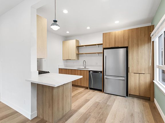 Brand new chef's kitchen with quartz countertops & brand new cabinetry and stainless appliances