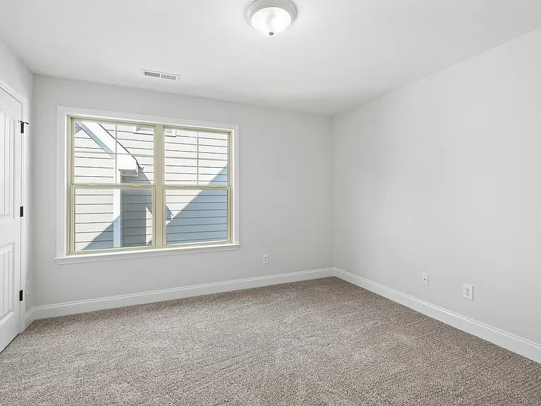 2nd upstairs bedroom with double door closets and large window for extra light.