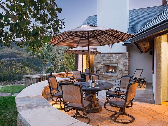 Patio is accessed from living room and also the dining room. 180 degree views, mostly facing National Forest. Patio has a fireplace (one of four fireplaces throughout the home). Also, has mowed lawn great for dogs or kids.