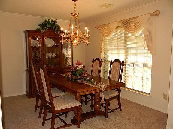 Dining offers crown molding, custom drapes and new carpet.