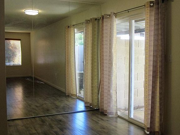 Floor to ceiling mirrored Dining area leading out to patio.