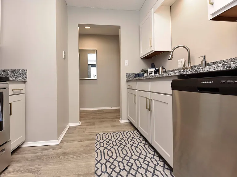 Kitchen with granite counters, stainless appliances, and modern cabinetry