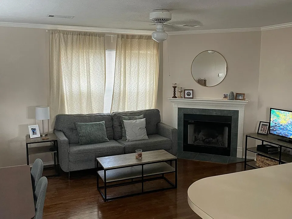 Living room with working fireplace and great natural light!