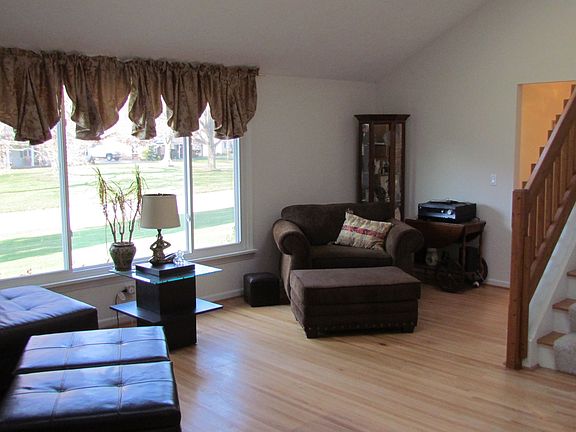Living Room with catherdal ceilings and recessed lighting.