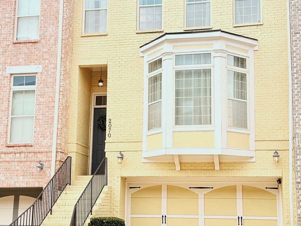 Exterior with two car garage & two outdoor parking spaces