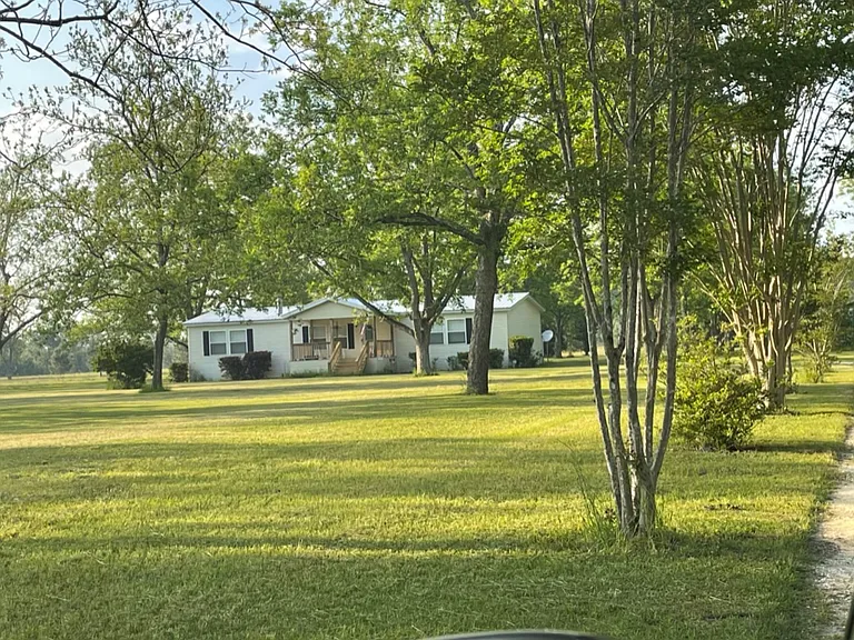 Front view of home from driveway. Covered front porch.