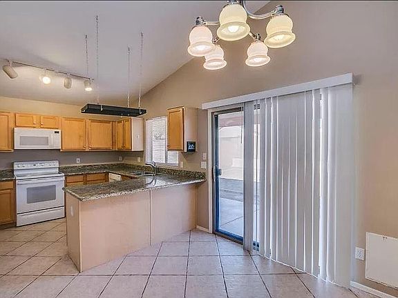 Kitchen and sliding glass door to the back yard. Pet door to right of sliding glass door.