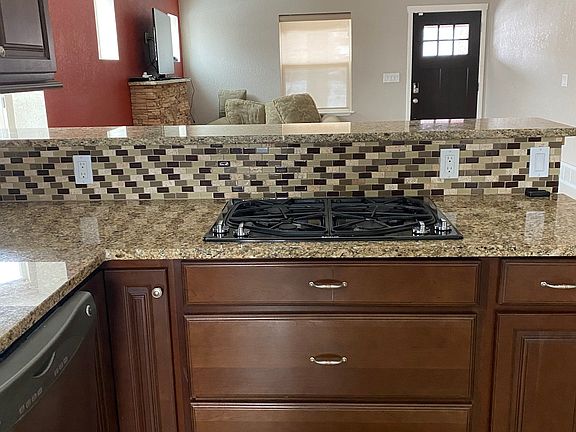 Kitchen Cooktop Looking into Dining Area and Living Room