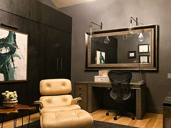 2nd bedroom as viewed as an office setting. Where painting is located is where the Murphy bed is located as viewed in other pictures. REAL Eames Lounge chair and foot rest.