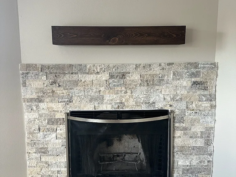 Beautiful new fireplace surround and a working wood-burning fireplace.