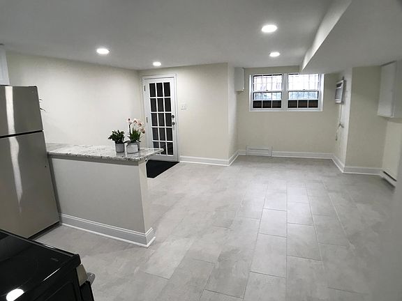Wider view of kitchen and living space