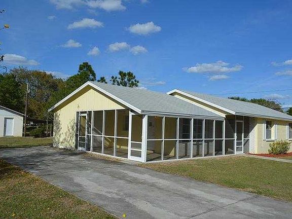 View of driveway, carport turned into screened pat