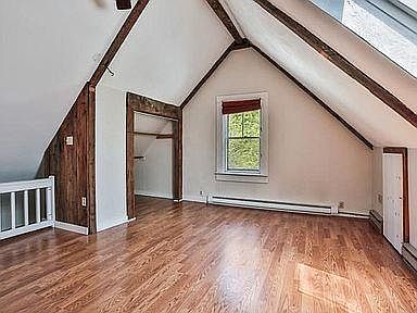 Living room with high ceilings, wooden beams and skylight window