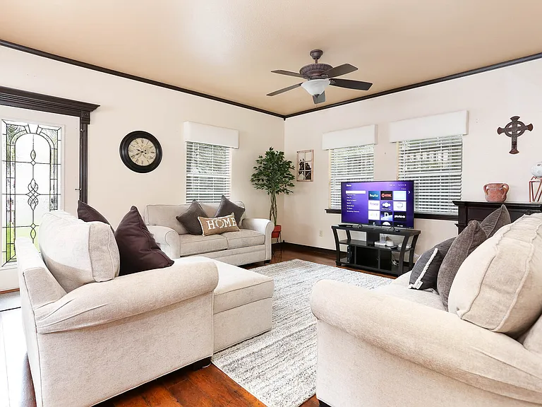 Formal living room furnished with electric fireplace. These are fold-out couches.