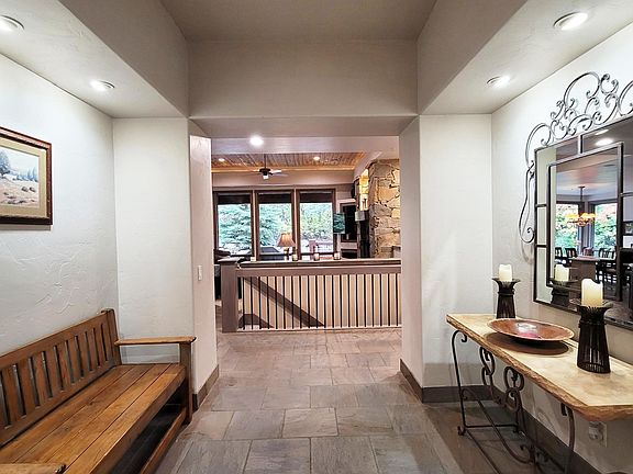 Entry with view of living room and forest