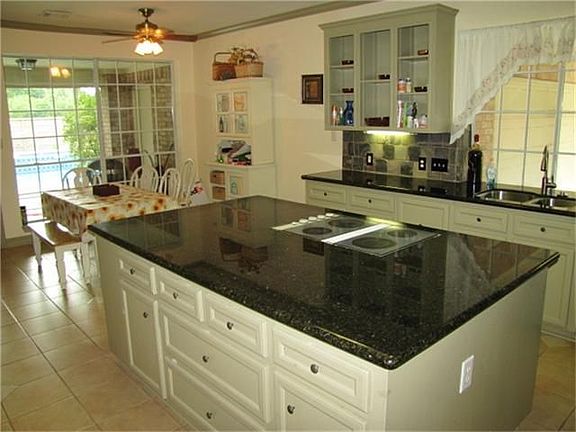 Kitchen and breakfast nook lead to the pool