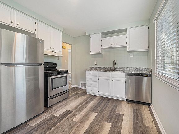Granite Countertop, Newer Refrigerator, Dishwasher, Lighting, Blinds and Flooring in Kitchen