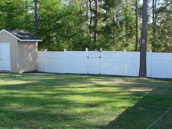 Backyard with sprinkler system and storage shed