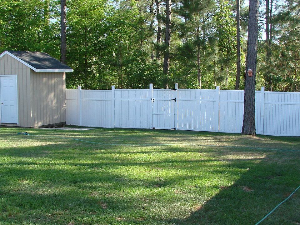 Backyard with sprinkler system and storage shed