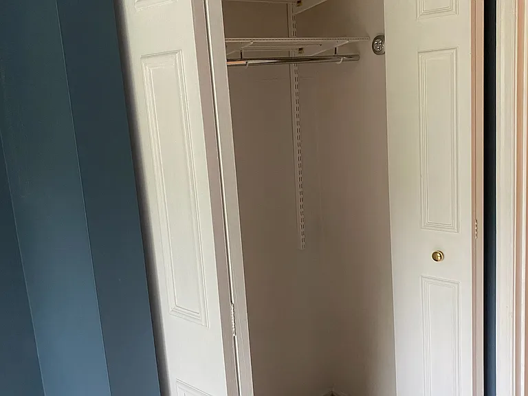 One of two closets in primary bedroom