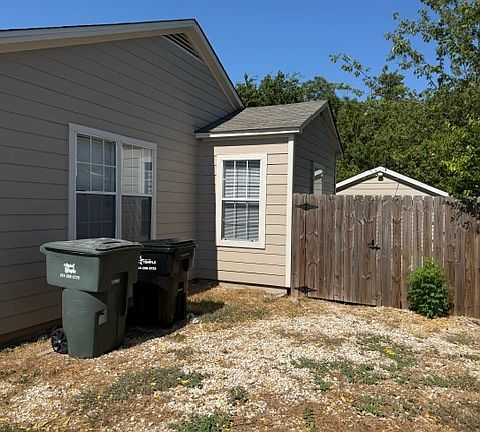 Side with gate to backyard and garage area