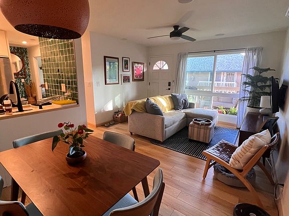 The view from the dining area looks out large floor to ceiling window onto the lanai.