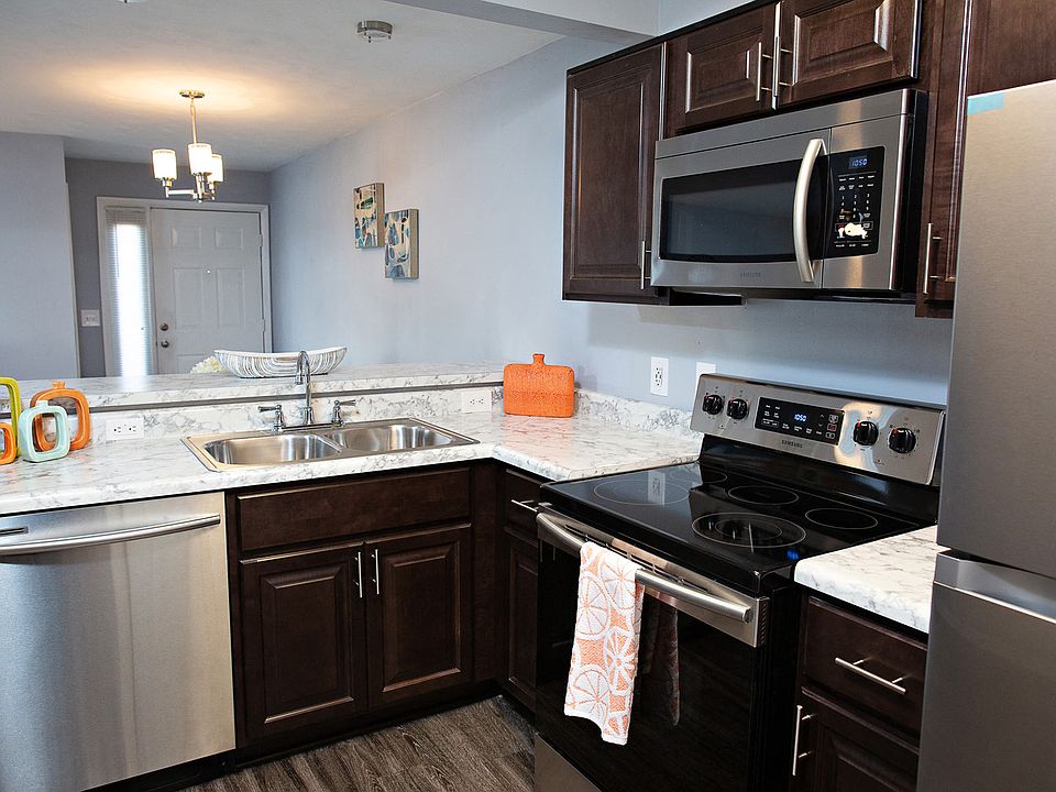 Renovated kitchen with dark cabinetry and stainless steel appliances.