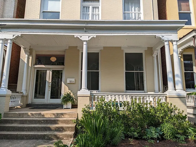 Front of house, your private side alley access is to the right, which leads you to the apartment.