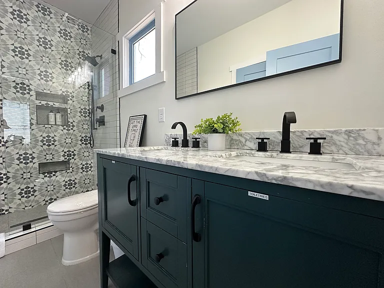 Labeled and stocked for your convenience, the primary bathroom offers spa-style amenities.