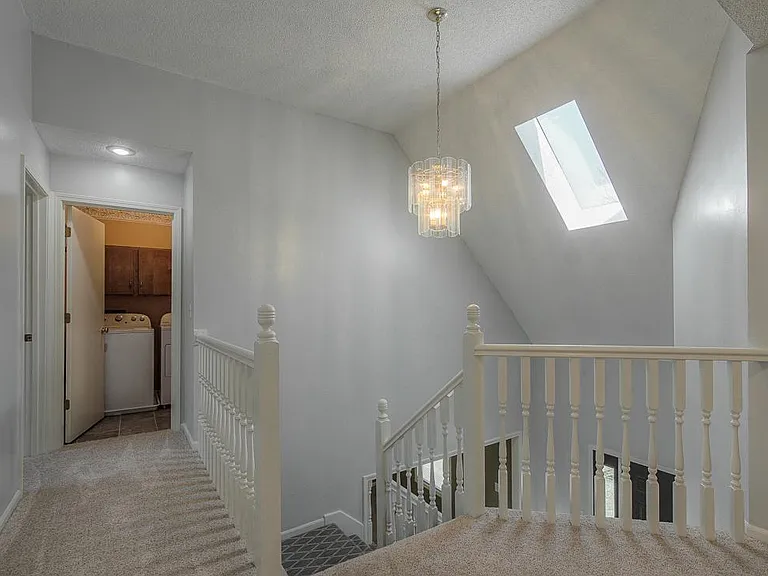 Upstairs, four large bedrooms and convenient laundry with new carpeting.