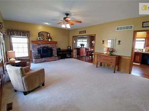 Large living room with wood burning fireplace and lots of windows!