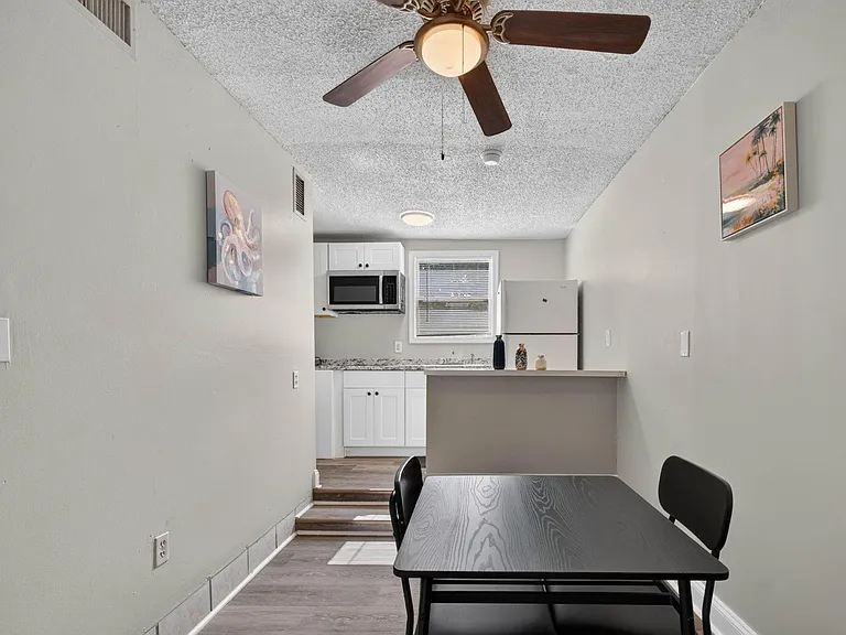 Eat-in kitchen with breakfast bar, ample cabinet storage, and a full appliance suite, plus a nearby dining nook.