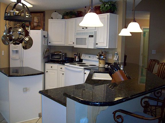 Kitchen with Granite Countertops and large bar overlooking great room