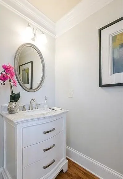 Vanity featuring an integrated sink, polished chrome faucet, and stone countertop